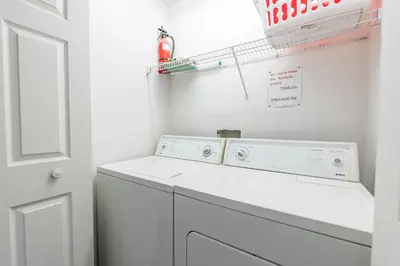 a white laundry room with a washer and dryer at MVP 1511ABIB LONG TERM in Kissimmee