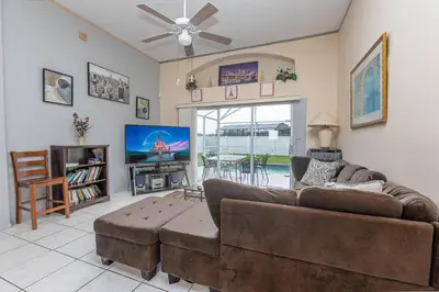 a living room with a couch and a flat screen tv at MVP 1511ABIB LONG TERM in Kissimmee