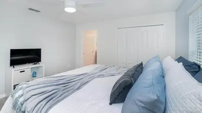 a bedroom with a bed with pillows and a television at CAP8859 in Kissimmee