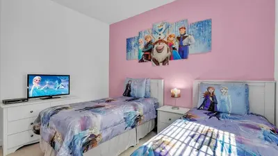 a bedroom with two beds and a flat screen tv at CAT8967 in Kissimmee