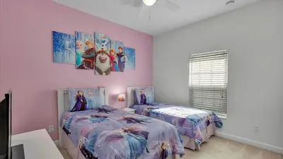two beds in a room with pink walls at CAT8967 in Kissimmee