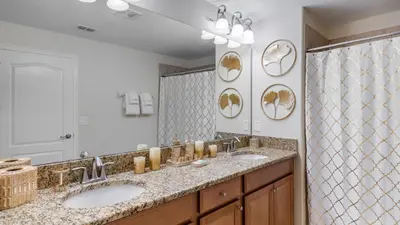 a bathroom with two sinks and a large mirror at CAP8949 in Kissimmee