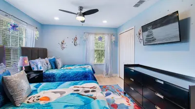 a bedroom with two beds and a flat screen tv at CAP8949 in Kissimmee