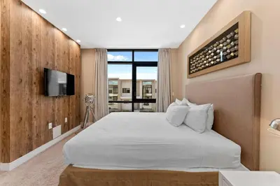 a bedroom with a white bed and a tv at Magic Village: 3 suítes c/ jacuzzi, 6min Disney in Orlando