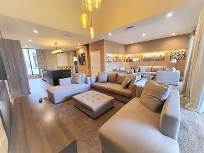 a large living room with white couches and a television at Magic Village: 3 suítes c/ jacuzzi, 6min Disney in Orlando