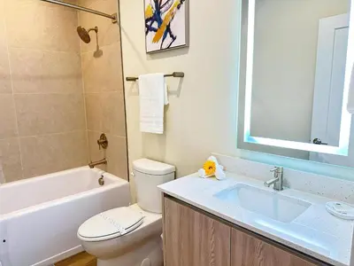 a bathroom with a sink and a toilet and a tub at TR1433SL - Island House Orlando in Orlando