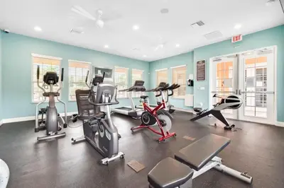 a gym with several exercise equipment in a room at TR1433SL - Island House Orlando in Orlando