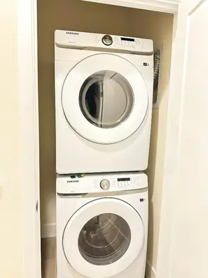 a washer and dryer in a small room at TR1386PNW - 9 guests - pool home close to Disney in Clermont