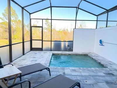 an indoor swimming pool in a glass house at TR1388PNW - Modern New Home 4 Bed in Clermont