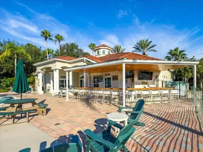 a house with chairs and tables and a patio at LDK2787 in Kissimmee