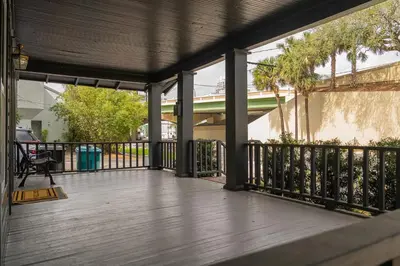 a porch with a wooden deck with a fence at Historic Orlando Casita Love Apt A with backyard in Orlando