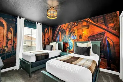 two beds in a room with a painting on the wall at Beautiful Disney House at Storey Lake in Kissimmee