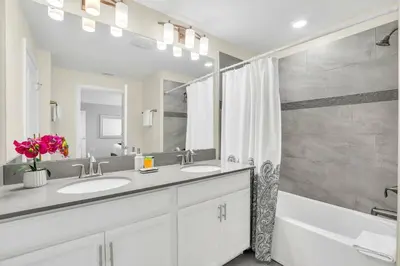 a bathroom with two sinks and a shower at Beautiful Disney House at Storey Lake in Kissimmee