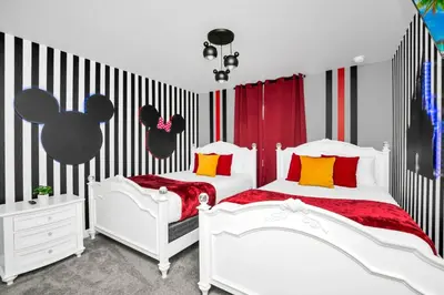 two beds in a bedroom with black and white stripes at Beautiful Disney House at Storey Lake in Kissimmee