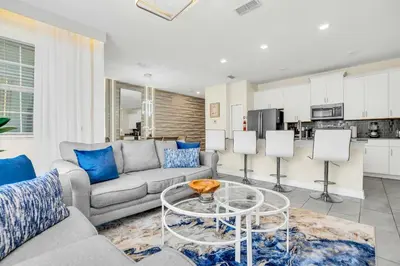 a living room with a couch and a table at Beautiful Disney House at Storey Lake in Kissimmee