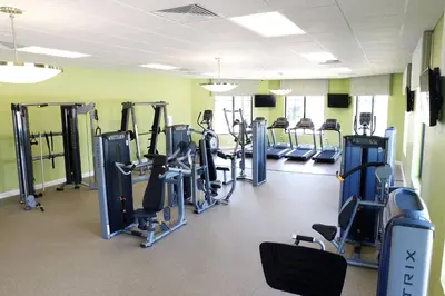 a gym with rows of treadmills and machines at Beautiful Disney House at Storey Lake in Kissimmee