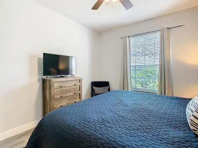 a bedroom with a bed and a flat screen tv at Windsor Hills Lovely 3BR Condo Slides Pool Disney in Orlando