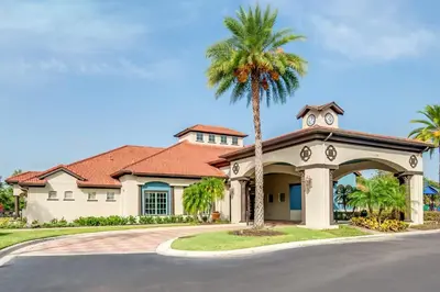 a house with a palm tree and a clock tower at Spacious Family Townhouse Sleeps 8 in Kissimmee