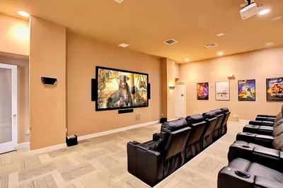 a waiting room with black chairs and a painting on the wall at Spacious Family Townhouse Sleeps 8 in Kissimmee