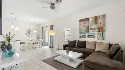 a living room with a couch and a table at Spacious Family Townhouse Sleeps 8 in Kissimmee