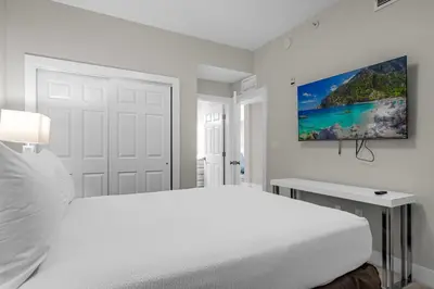 a white bedroom with a white bed and a desk at 3 Bedroom Spacious Condo at WorldQuest near Disney- 22749 in Orlando