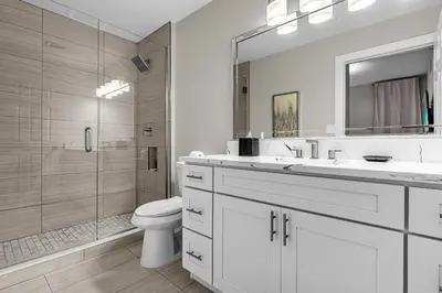 a white bathroom with a toilet and a shower at 3 Bedroom Spacious Condo at WorldQuest near Disney- 22749 in Orlando
