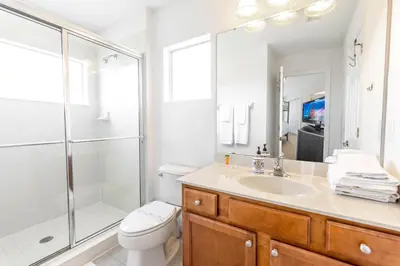 a bathroom with a shower and a toilet and a sink at Gorgeous Villa with Pool and Spa in Kissimmee