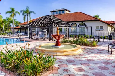 a fountain in a courtyard next to a house at Gorgeous Villa with Pool and Spa in Kissimmee