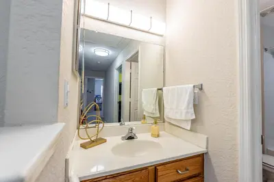 a bathroom with a sink and a mirror at Spectacular townhouse with themed room in Kissimmee