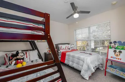 a bedroom with bunk beds and a mickey mouse bedroom at Spectacular townhouse with themed room in Kissimmee