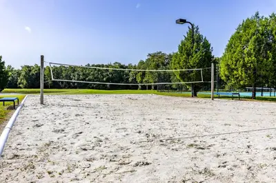 an empty volleyball court with a net in a park at Spectacular townhouse with themed room in Kissimmee
