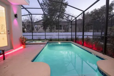 a swimming pool in a house with a greenhouse at Ravello Villa Storey Lake in Kissimmee