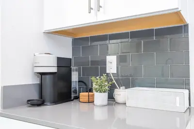a kitchen counter with a coffee maker and plants on it at Ravello Villa Storey Lake in Kissimmee