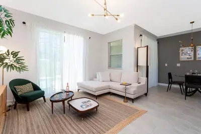 a living room with a couch and a table at La Vita E Bella 4 Bedroom Storey Lake Condo in Kissimmee