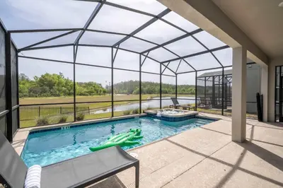 an indoor swimming pool with a retractable roof at Stunning Game Room & Pool Jacuzzi Storey Lake 2799 in Kissimmee