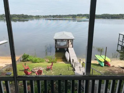 a view of a dock on a lake with chairs at Lakefront with Dock on Private Lake Florence near Montverde Academy in Montverde