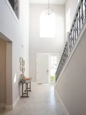 a hallway with a staircase in a white room at Exclusive Orlando Getaway close to Disney in Kissimmee