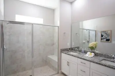 a bathroom with a glass shower and a sink at Exclusive Orlando Getaway close to Disney in Kissimmee