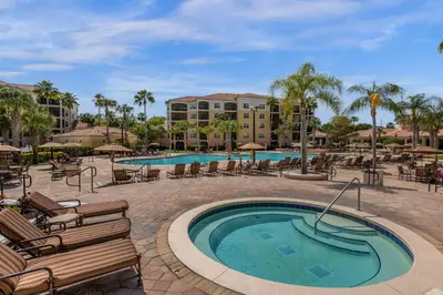 a swimming pool with lounge chairs and a resort at 2 Bedroom Condo 6403 in Orlando