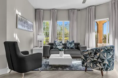 a living room with a couch and chairs and a table at WorldQuest Resort in Orlando