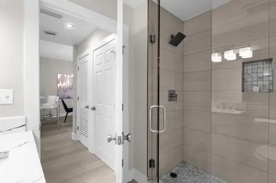 a bathroom with a shower and a glass door at WorldQuest Resort in Orlando