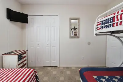 a bedroom with an american flag on the wall at Ideal for Couples or Families looking for a Vacation Home with Private Pool and Yard in Kissimmee