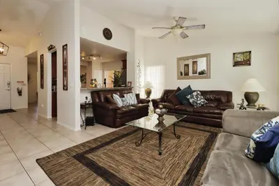 a living room with leather couches and a coffee table at Ideal for Couples or Families looking for a Vacation Home with Private Pool and Yard in Kissimmee
