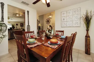 a dining room with a wooden table and chairs at Ideal for Couples or Families looking for a Vacation Home with Private Pool and Yard in Kissimmee