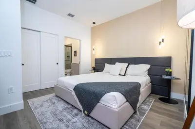 a bedroom with a large bed with a black headboard at Doppio Westside in Orlando
