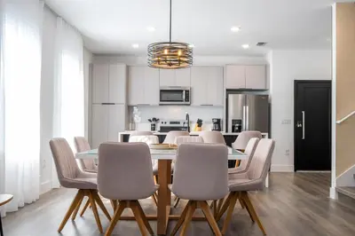 a kitchen and dining room with a table and chairs at Doppio Westside in Orlando