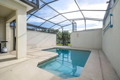 an indoor swimming pool with a glass roof at Nice Vacation Townhouse w Pool SL4893 in Kissimmee