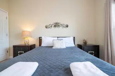 a bedroom with a blue bed with two night stands at Nice Vacation Townhouse w Pool SL4893 in Kissimmee