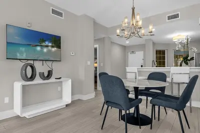 a dining room and living room with a table and chairs at Unit 5203 Worldquest in Orlando