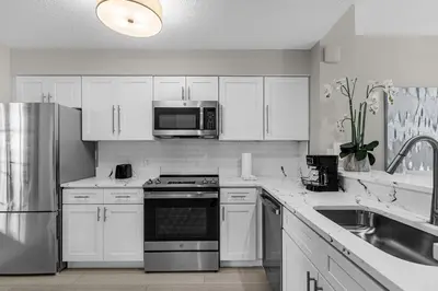 a kitchen with white cabinets and a stainless steel appliance at Unit 5203 Worldquest in Orlando